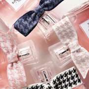 Steklenička Miss Dior Eau de Parfum s srebrno pentljo in rožnato obarvano dišavo